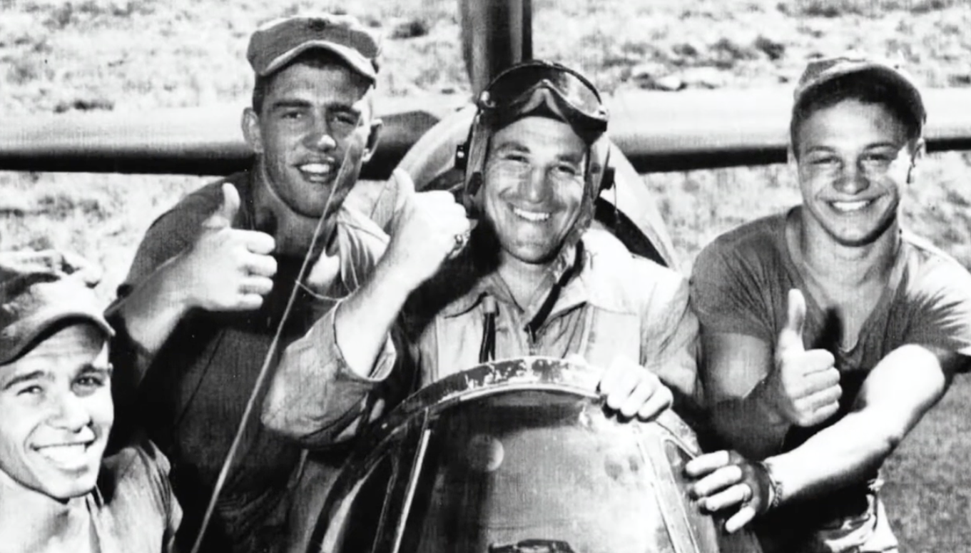 Archive photo: Marines giving a thumbs-up beside an aircraft